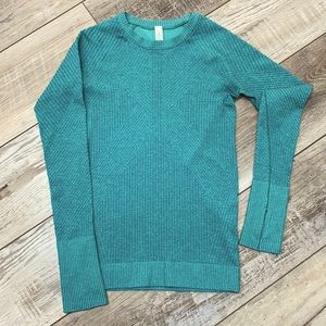 Lululemon women’s dark teal fitted running shirt with long sleeves.